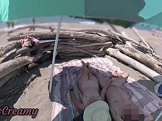 Wife gives outdoor handjob with cumshot on beach