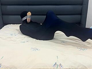 slave sniffs shoes while encased in pantyhose prison