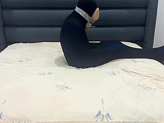 slave sniffs shoes while encased in pantyhose prison
