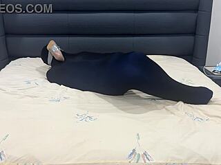 slave sniffs shoes while encased in pantyhose prison