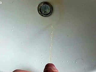 Boy is pissing in the sink and makes stinky farts
