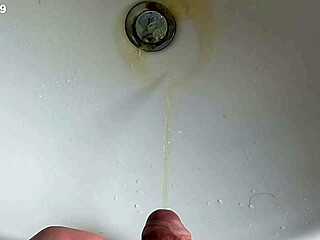 Boy is pissing in the sink and makes stinky farts