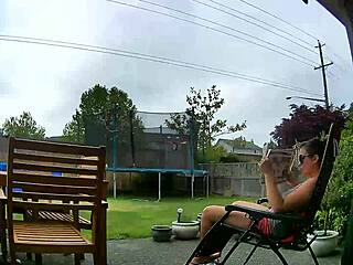 A milf babe flashes her big tits outdoors while the landscaper spies