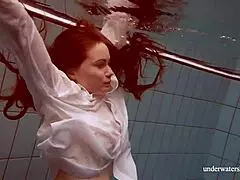 Lola shows off her big natural tits swimming underwater.