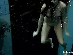 Blackhaired Aneta dives gracefully into the refreshing pool waters