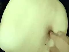 The guy indulges in exploring the curvy milf's navel during an intimate belly massage.