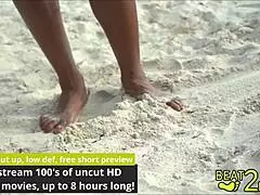 giggles' bare feet tickled sandy on beach close-up